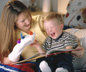 Mother showing child a sock puppet