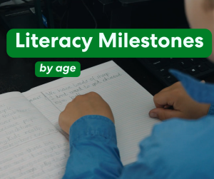 Over the shoulder of a bush kid pointing to words written in a book with the words over the image saying "Literacy Milestones by Age"